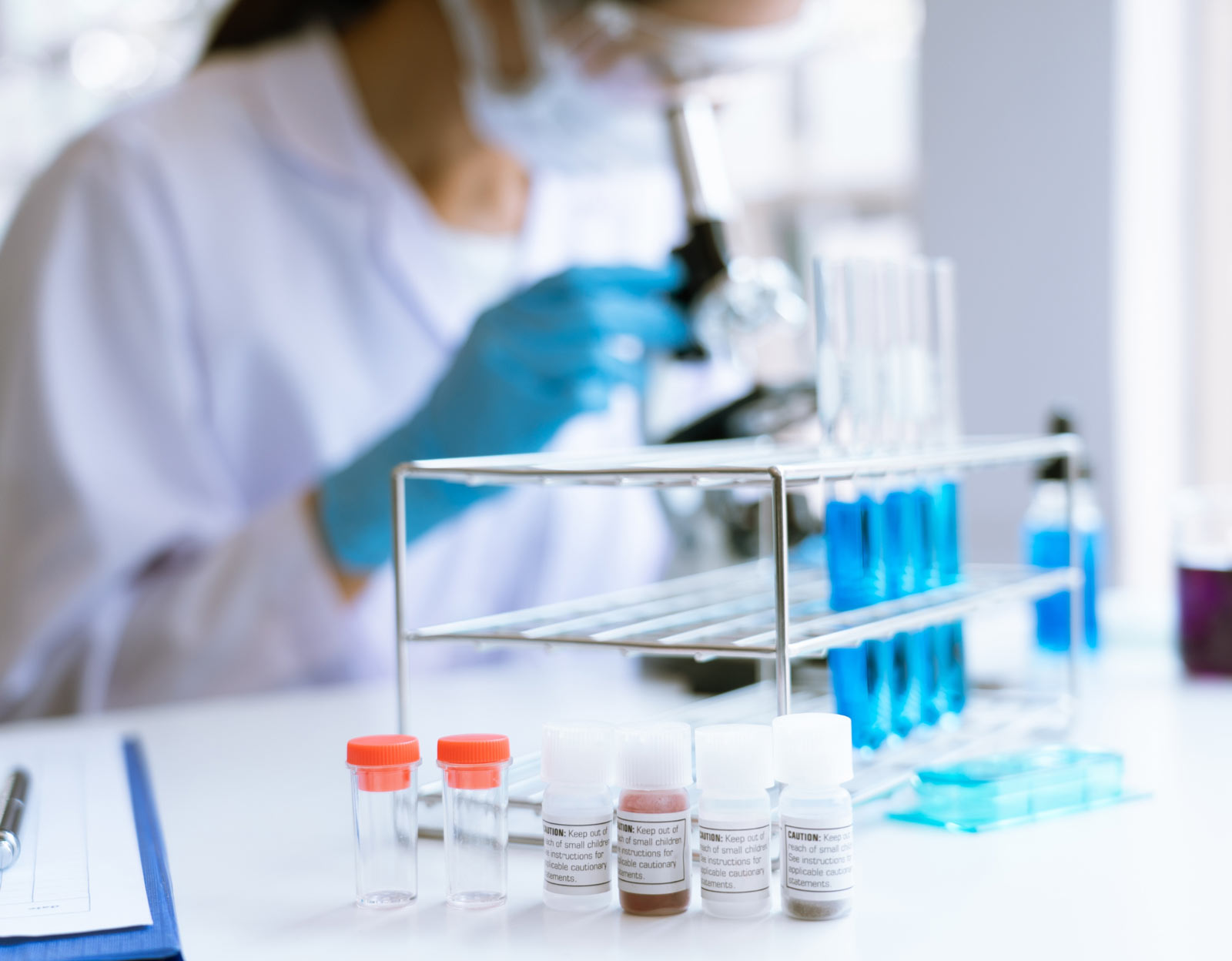 scientist looking through microscope