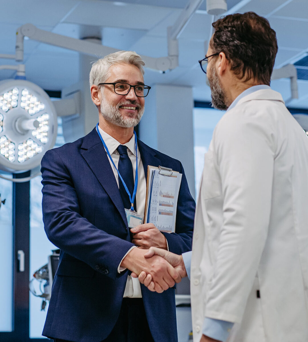 pharmaceutical sales representative shaking hands with doctor