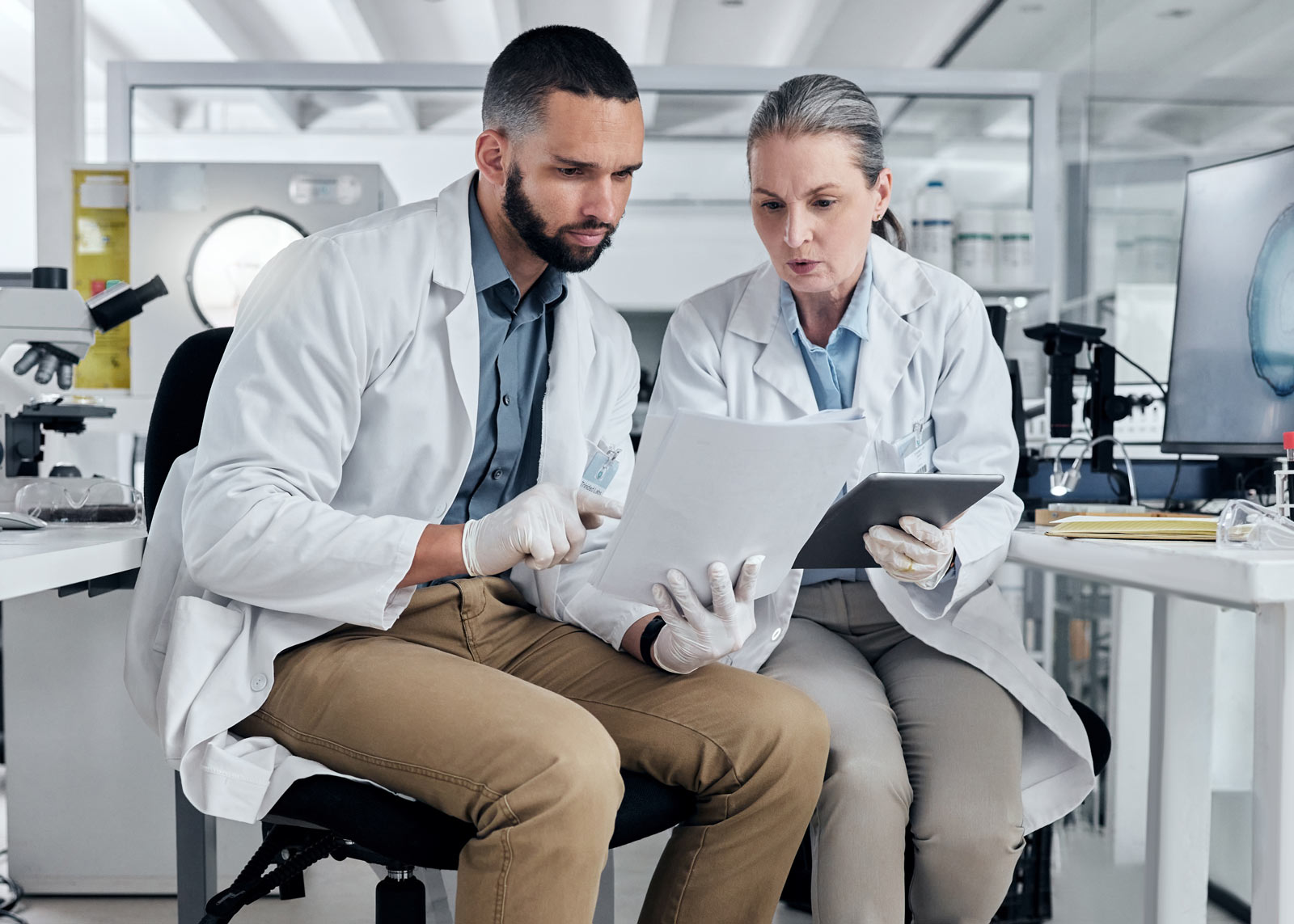 two scientists looking at papers