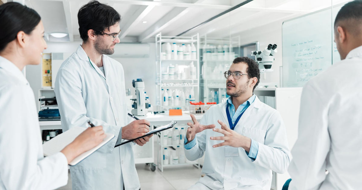 four scientists working together in a lab