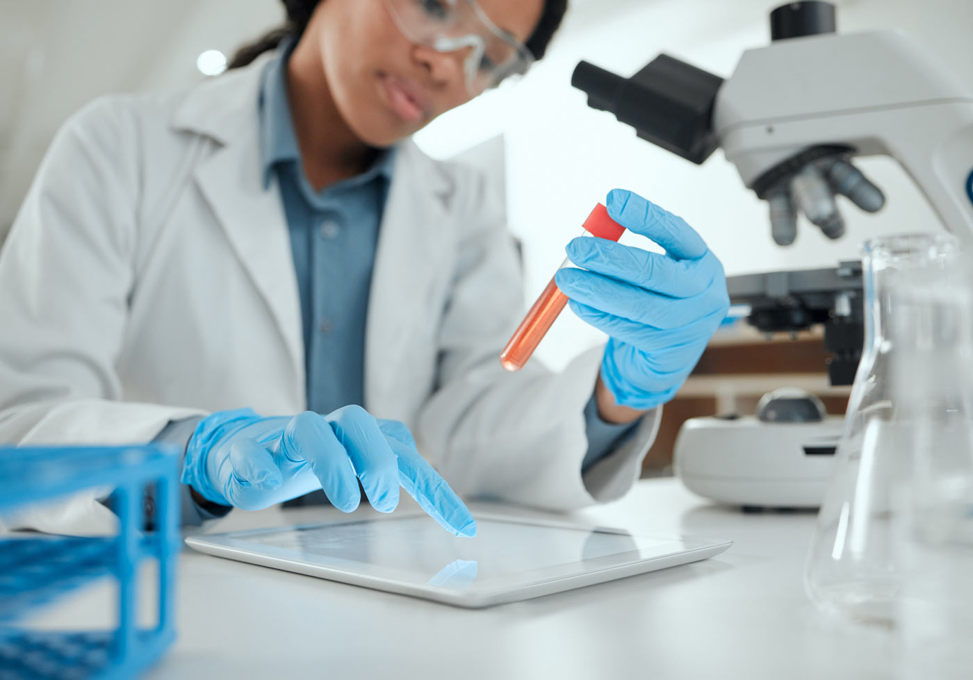 scientist with test tube and computer tablet in lab for DNA analysis